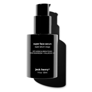 A person with medium-brown skin dispenses JACK HENRY - SUPER FACE SERUM from a black bottle. Overlay text lists orange stem cells, snow mushroom, neroli hydrosol, and hyaluronic acid—each shown with images and benefits.