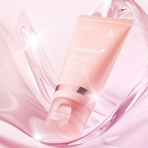 A pink tube of KOSMIC KBEAUTY SKINCARE MEDICUBE - COLLAGEN NIGHT WRAPPING MASK, 75ML is showcased against a clear, glossy liquid backdrop. The packaging emphasizes collagen extract and intensive night care benefits, making it an ideal overnight mask for radiant skin and long-lasting hydration.