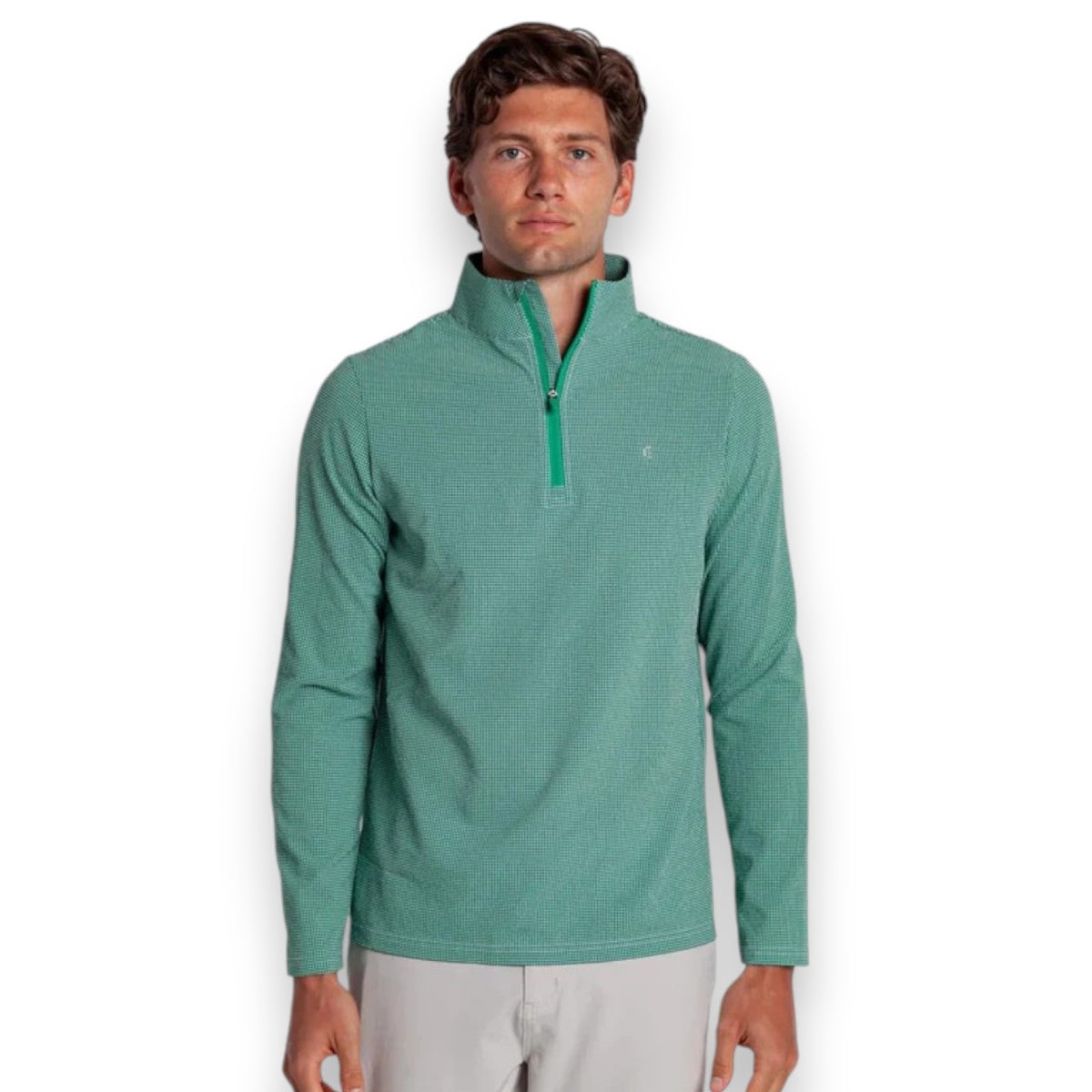A young man faces forward against a white background, wearing the CRIQUET - SEERSUCKER PERFORMANCE PULLOVER IN GREEN with moisture-wicking fabric and light gray pants.