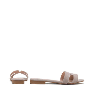 The image depicts the MICHELE LOPRIORE - H SLIDE, a single brown leather slide sandal with an open-toe design. The upper features two wide straps with geometric cutouts. The thin sole appears to be made of light brown wood-like material. Made in Italy by MICHELE LOPRIORE, the sandal is displayed against a plain white background.