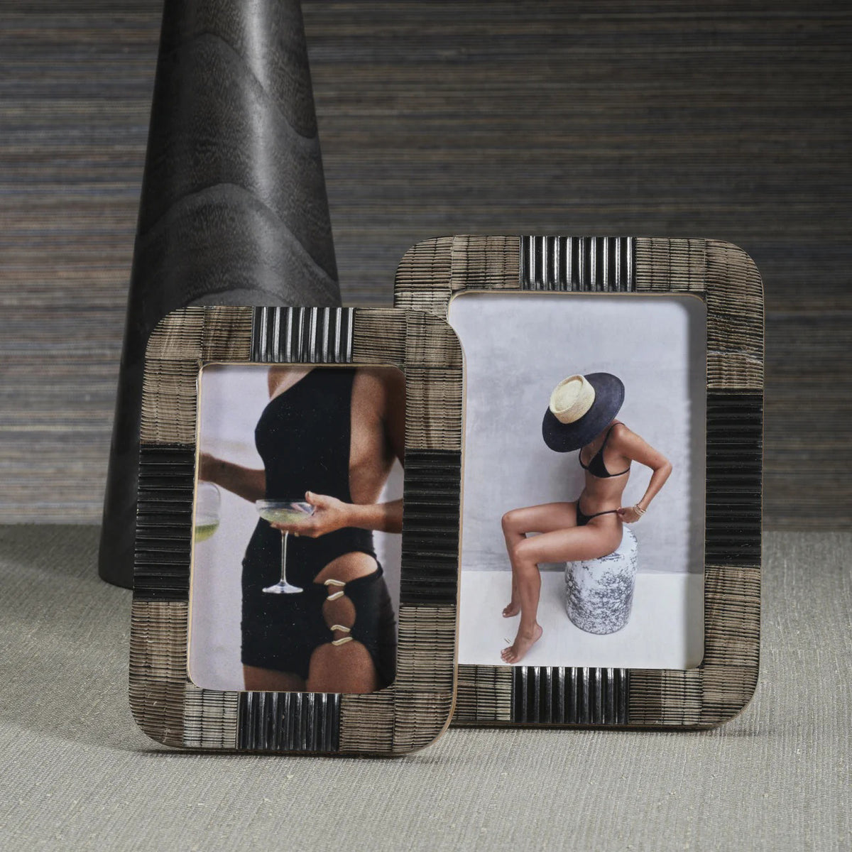 The ZODAX BLACK CHISELED HORN PHOTO FRAME 4X6 features a rectangular, textured design. Displayed is a photo of a woman in a black dress holding a wine glass, with her face not shown.