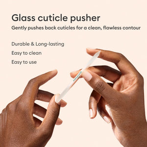 The MANUCURIST - GLASS CUTICLE PUSHER by MANUCURIST INC is a reusable, double-ended white glass cuticle tool with pointed tips and "manucurist PARIS" printed in green at the center, shown on a plain white background.