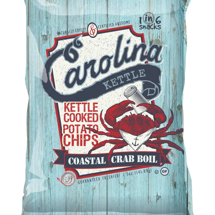 A light blue bag with a rustic wooden plank design labeled &quot;CAROLINA KETTLE - CRAB BOIL CHIPS 5OZ&quot; from the brand &quot;1 IN 6 SNACKS&quot;. Featuring a red crab holding a map, the text &quot;Certified Awesome&quot; and &quot;Guaranteed Fressher,&quot; 5 oz (141.8g), GF, and the &quot;1 in 6 Snacks&quot; logos. Enjoy this savory treat inspired by Southern tradition.
