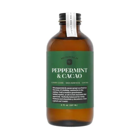 An 8 fl oz brown glass bottle from YES COCKTAIL CO. with a black cap, featuring a green label that reads “PEPPERMINT &amp; CACAO” in white text. The YES COCKTAIL CO. PEPPERMINT &amp; CACAO COCKTAIL SYRUP is an all-natural mixer blending candy cane freshness with decadent cocoa for a festive flavor experience.