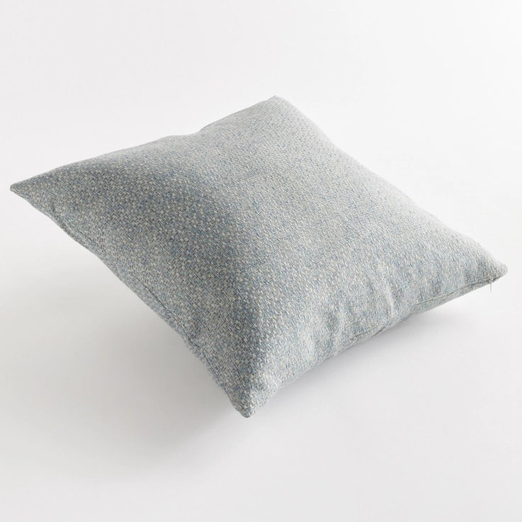 The NAPA HOME AND GARDEN - BLAKE SQUARE OUTDOOR PILLOW 20&quot; is a pale blue, textured pillow with a subtle woven Jacquard pattern. Its soft, muted appearance adds weather-resistant elegance against a white background.