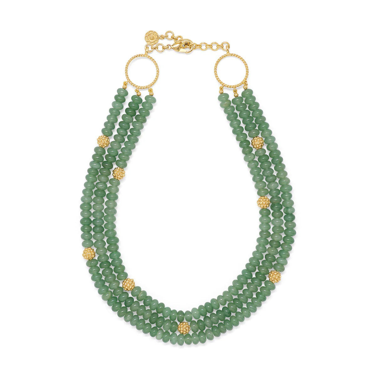 The CAPUCINE DE WULF - BERRY AND BEAD TRIPLE STRAND NECKLACE MEADOW JADE is a striking accessory with triple strands of jewel-toned jade beads, accented by small gold spheres and two large gold rings near the adjustable clasp.