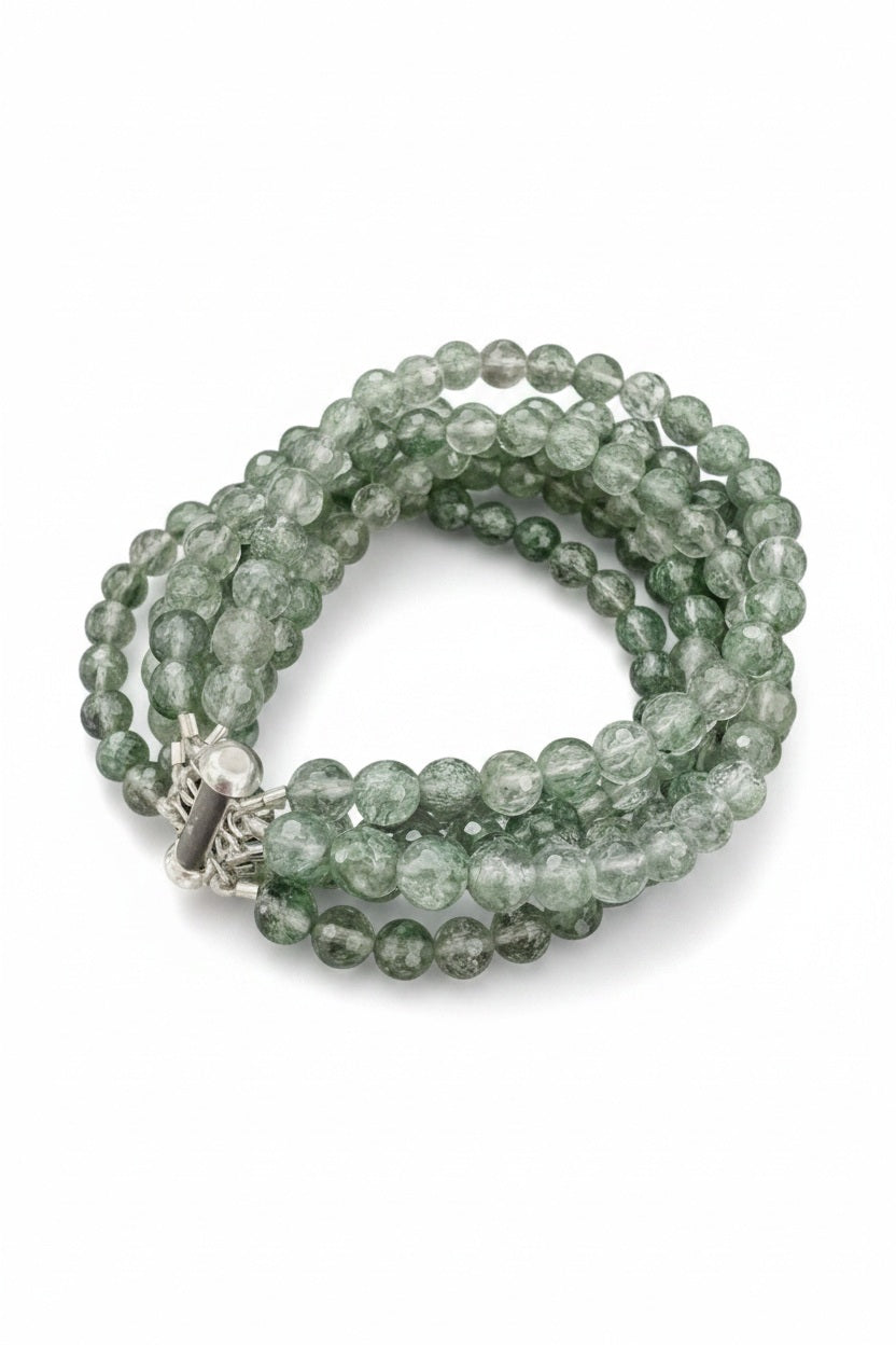 The ANN LIGHTFOOT "Five Strand Green Quartz Bracelet" features coiled, round translucent green beads with a crackled texture, fastened by a stainless steel clasp against a plain white background.