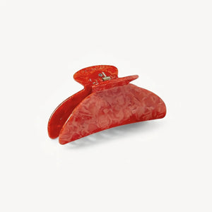 The MACHETE - MIDI HAIRLOOM CLAW IN POPPY by MACHETE is a large orange marbled Italian acetate hair claw with wide teeth, shown against a plain white background.