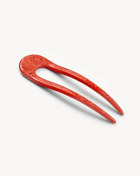 A smooth, black MACHETE - FRENCH HAIR PIN with two prongs, crafted from Italian acetate by MACHETE, rests on a plain white surface.