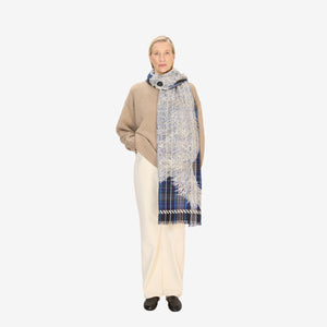 The INOUI FREDDY DOG SCARF IN 3D BLUE by INOUI is a rectangular, blue plaid wool-cotton scarf featuring white sketch-like dog drawings and fringed edges on both short sides, made in India.