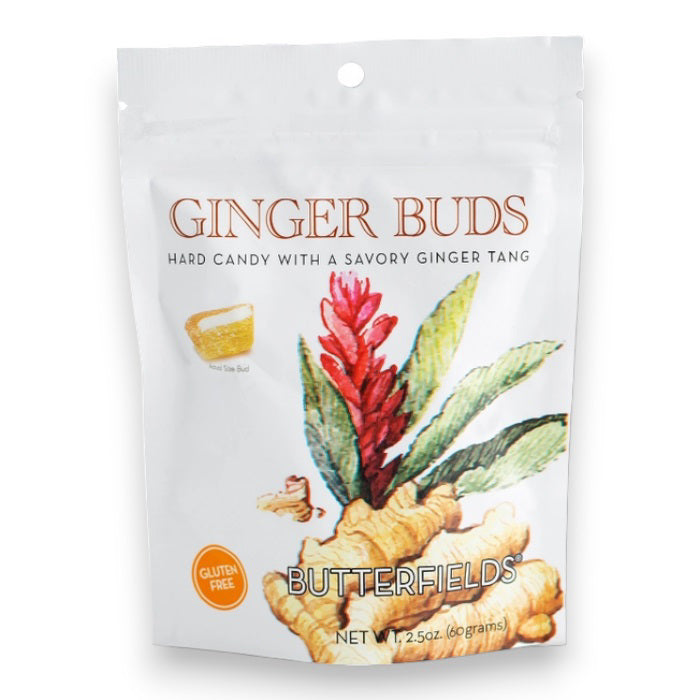 The image displays a white packet of BUTTERFIELDS - GINGER BUDS hard candy. The front features an illustration of a ginger plant with red flowers and green leaves. The text reads &quot;Ginger Buds&quot; and &quot;Gluten Free,&quot; highlighting its natural ginger flavor, with the net weight shown as 2.5 oz (60 grams).