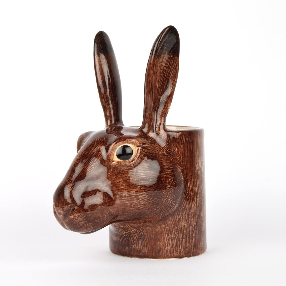 The QUAIL DESIGNS QUAIL CERAMICS - HARE PENCIL POT is a 15 cm hand-painted stoneware pencil holder shaped like a brown hare's head with textured fur, upright ears, and glossy finish. Dishwasher safe and shown on a plain white background.