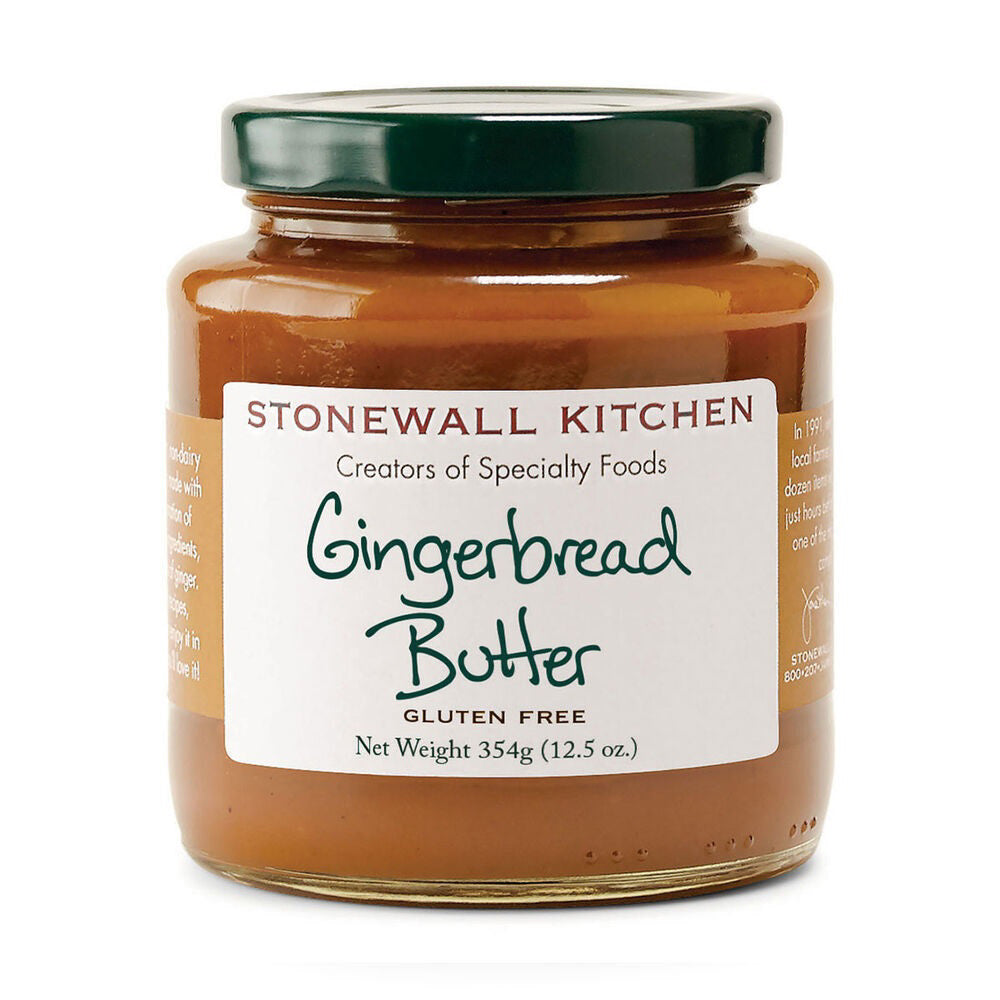 The STONEWALL KITCHEN - GINGERBREAD BUTTER is displayed, featuring a sweet spice flavor. Its label emphasizes that the product is gluten-free and has a weight of 354g (12.5 oz). The jar comes with a green lid, showcasing the branding of Stonewall Kitchen as creators of specialty foods. This delicious spread is also non-dairy.