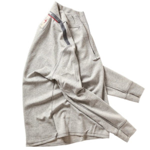 RELWEN - Wool and Cotton Quarter Zip in Light Grey Heather, a long-sleeve pullover sweater from RELWEN, is laid flat on a white background. This lightweight, layer-ready sweater features a soft, slightly textured double-faced knit fabric and displays a visible tag near the quarter-zip collar.