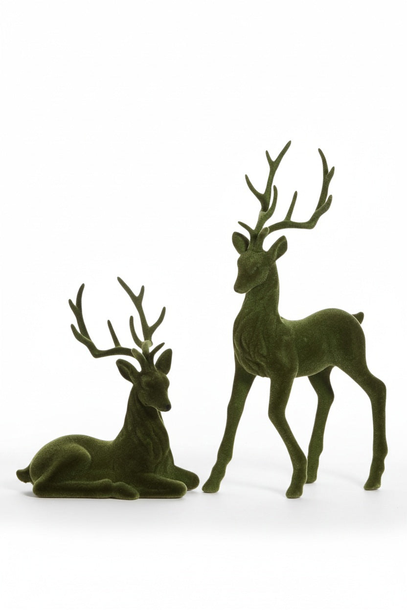 Two GREEN FLOCKED DEER decorative figurines by RAZ IMPORTS, one standing and one lying down.