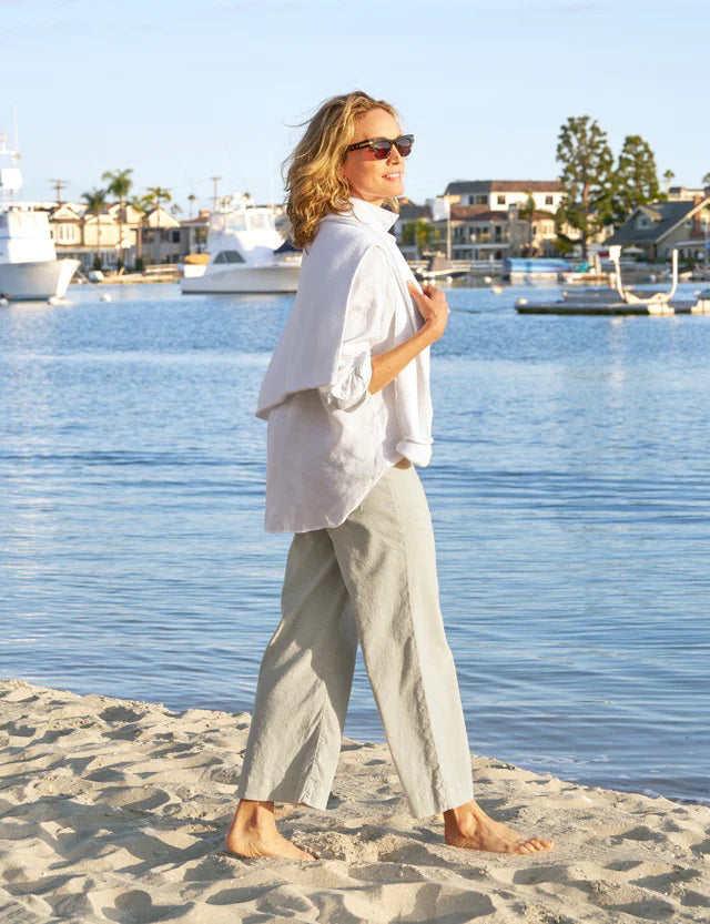 The FRANK &amp; EILEEN Wexford Wide Leg Linen Pants in Cement are showcased against a light textured background. These Italian Performance Linen pants feature a fitted waist with belt loops and a zip fly with button closure. The bottom hems are neatly finished, providing a clean, tailored appearance.