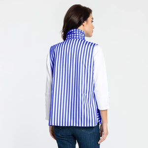 A woman with shoulder-length dark hair is wearing the HINSON WU - LAUREN VEST, which is fully reversible and features a blue and white gingham pattern, over a white long-sleeve shirt. She is standing sideways, looking at the camera with her left hand resting near her waist. The background is plain white.