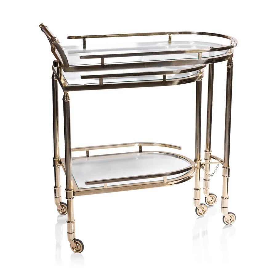 The SPIGA GOLD BAR CART by ZODAX features a vintage Italian-inspired design with elegant gold framing, mirrored glass shelves on both tiers, and smooth-rolling four-wheel mobility. Displayed against a white background, this piece is both stylish and functional.