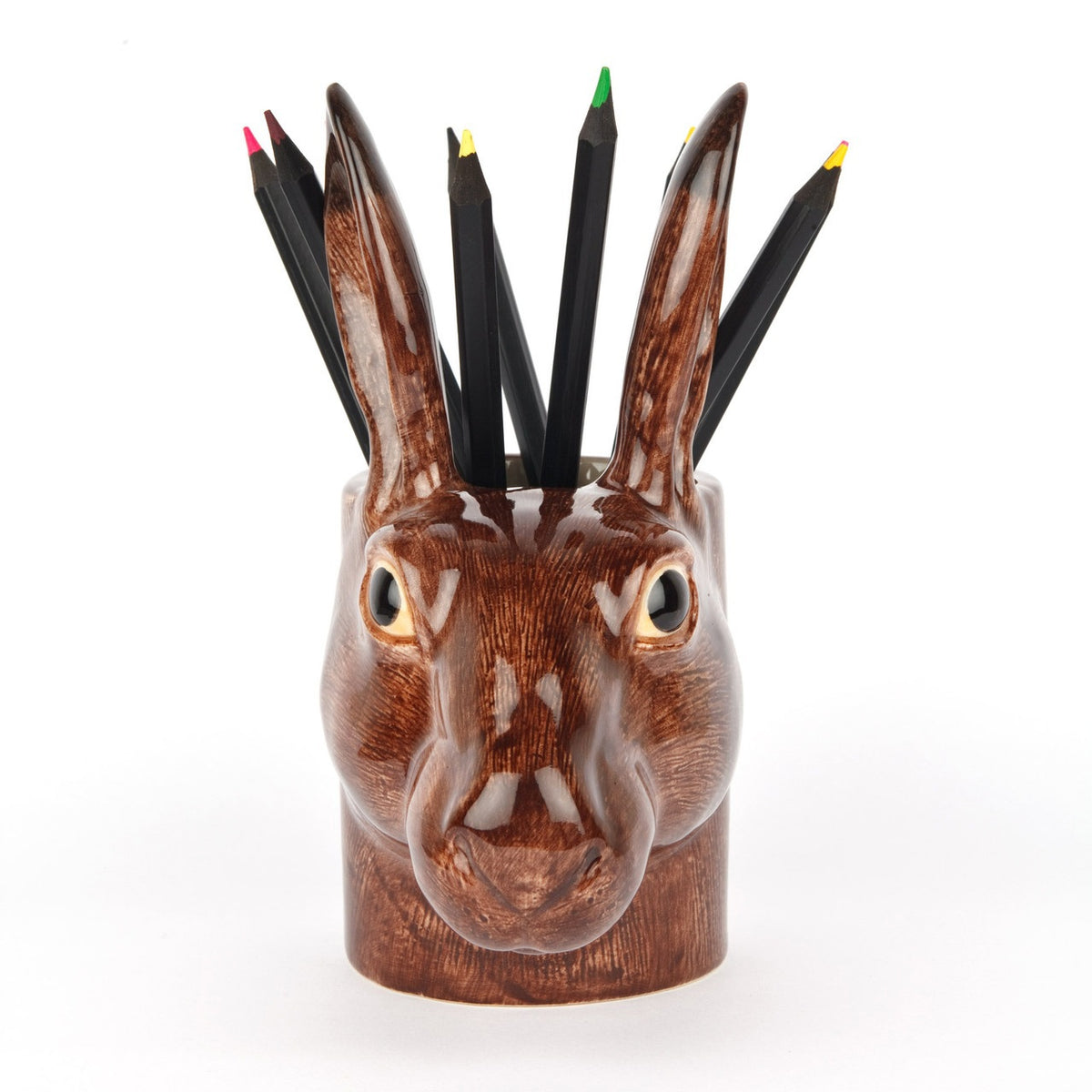 The QUAIL DESIGNS QUAIL CERAMICS - HARE PENCIL POT is a 15 cm hand-painted stoneware pencil holder shaped like a brown hare's head with textured fur, upright ears, and glossy finish. Dishwasher safe and shown on a plain white background.