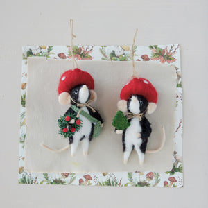 Two WOOL FELT MOLE IN MUSHROOM HAT ORNAMENTs shaped like mice; one holds a green sprig and the other a small wreath.