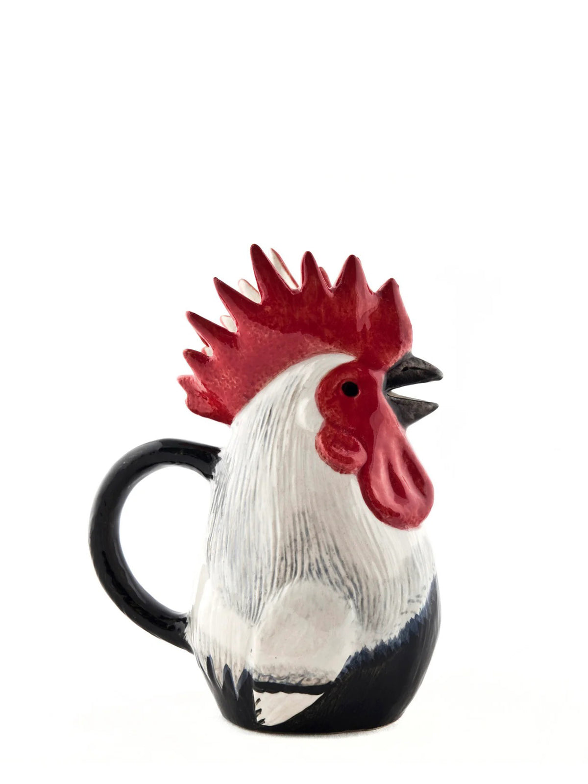 The QUAIL CERAMIC - DORKING ROOSTER JUG by QUAIL DESIGNS is a glazed ceramic mug shaped like a rooster, with a red comb, black beak, and white and black feathers reminiscent of a classic ceramic cockerel jug, displayed against a plain white background.