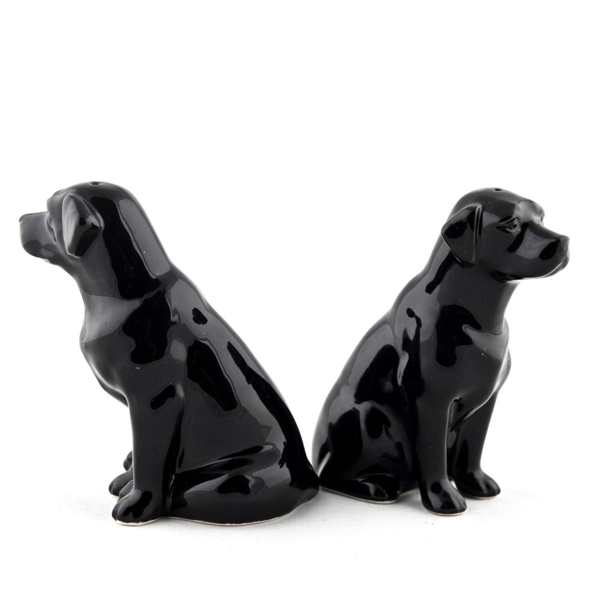 The QUAIL CERAMICS - BLACK LABRADOR SALT AND PEPPER SET from QUAIL DESIGNS features two glossy black handpainted labrador stoneware figurines. Charming and dishwasher proof, they make a delightful addition to any table.