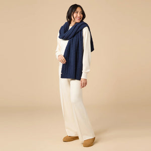 A dark navy blue SOFTIES - CABLE KNIT MARSHMALLOW SCARF draped in a loop.