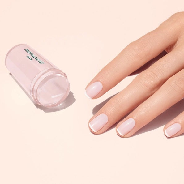 The MANUCURIST - MANI STAMPER by MANUCURIST INC is a clear silicone stamper in a box labeled “manucurist PARIS” and “Mani stamper,” designed for flawless nail art and perfecting your French manicure.