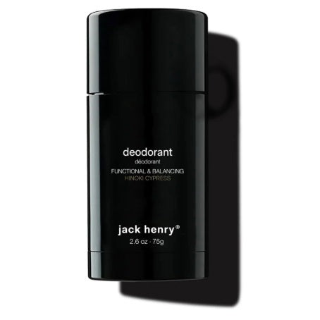 A person holds a black stick of JACK HENRY - DEODORANT HINOKI CYPRESS near their lips. Text highlights zinc ricinoleate, lactobacillus ferment, magnesium, and meadowfoam seed in this natural, aluminum-free JACK HENRY formula.