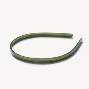 The MACHETE Ultralight Thin Headband in Meadow is a simple, slim green plastic accessory with a slight sheen, shown against a plain white background.