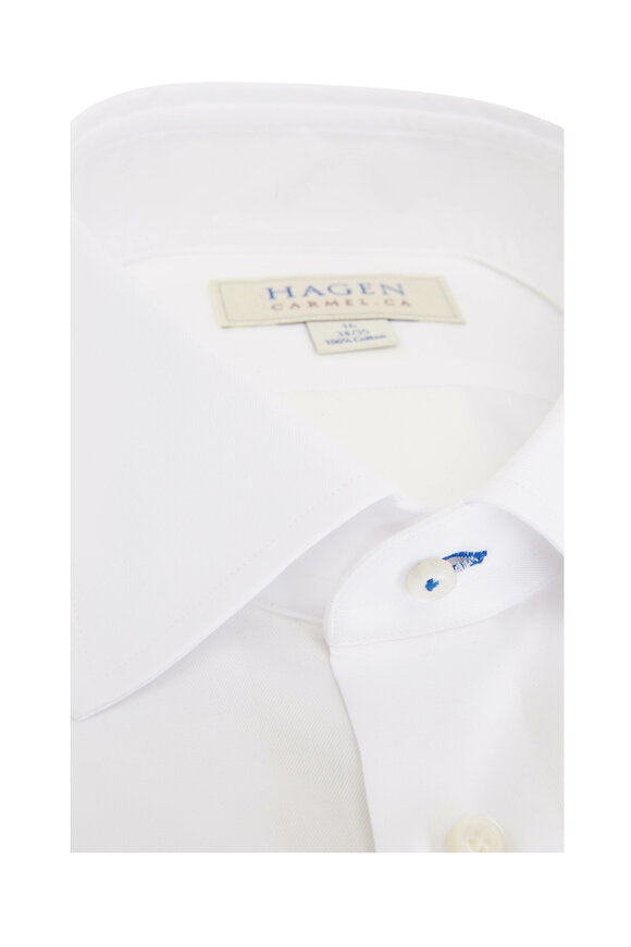 The HAGEN - COTTON DRESS SHIRT IN WHITE by HAGEN features premium cotton, a modern spread collar, white buttons, and a visible “Hagen Caremica” label inside the collar, displayed against a plain background.