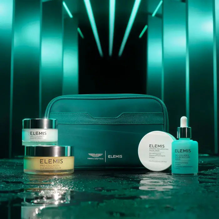 The ELEMIS - ASTON MARTIN ICONIC SKINCARE COLLECTION MEDIUM by ELEMIS - STEINER includes a jar, dropper bottle, cream container, and pump bottle in green and white packaging next to a matching pouch and box. Features their iconic cleansing balm.