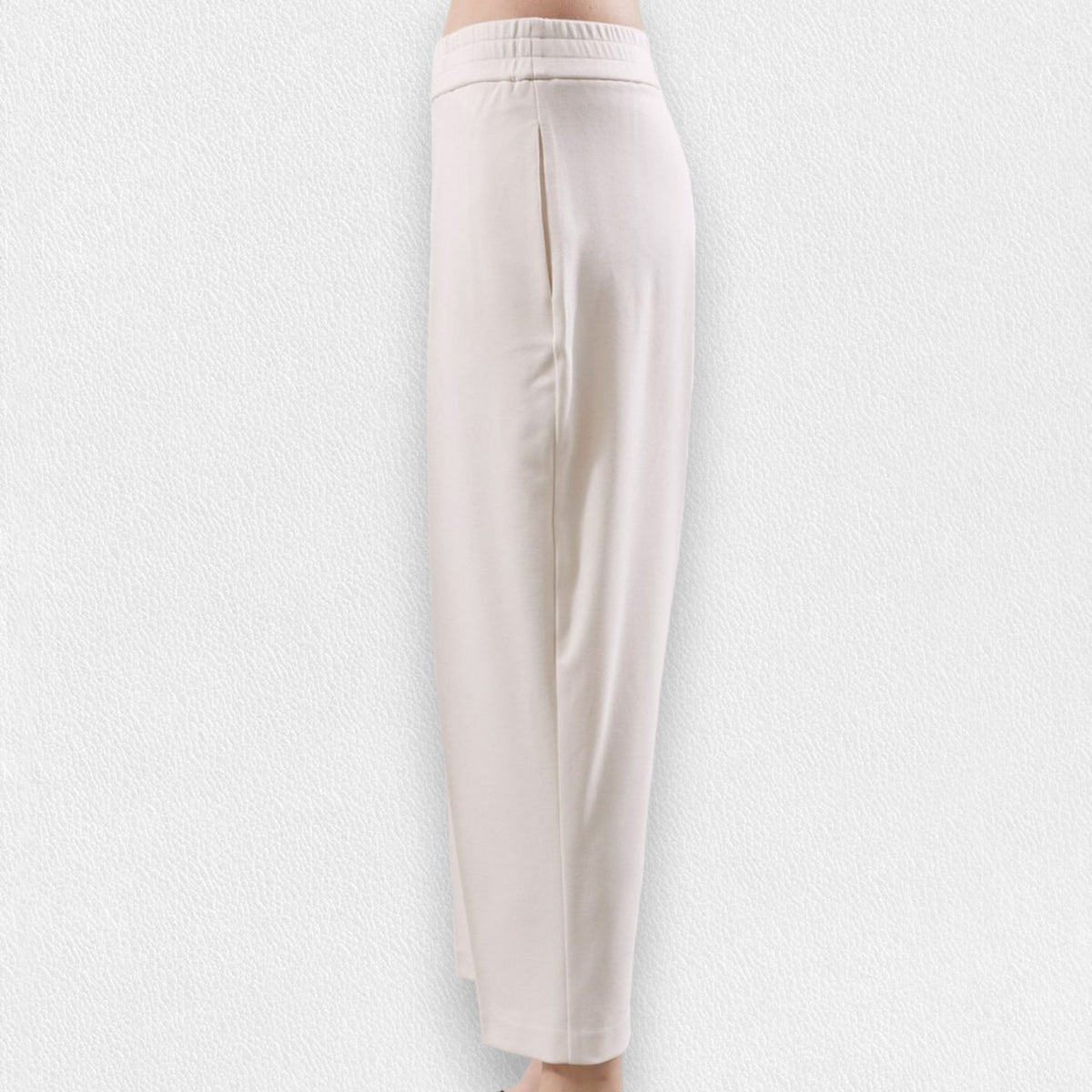 The MEIMEIJ - PONTE PULL ON TROUSER, a pair of beige, high-waisted, straight-leg pull-on trousers from MEIMEIJ, is displayed against a light textured background. These pants feature an elastic waistband, side pockets, and a simple, minimalist design.