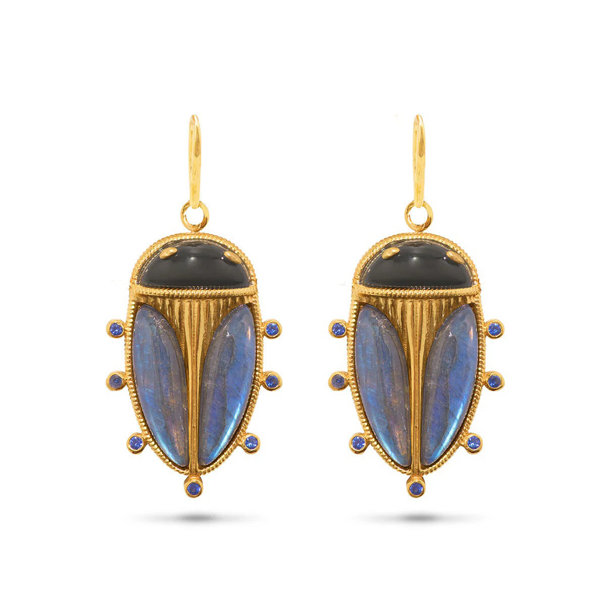 The CAPUCINE DE WULF Scarab Petite Drop Blue Labradorite/Black Agate Earrings by Capucine de Wulf feature a pair of gold drop earrings designed to resemble beetles. Adorned with black agate and iridescent blue labradorite stones, they include six small circular blue accents along the edges and each earring is attached with an 18K gold hook.