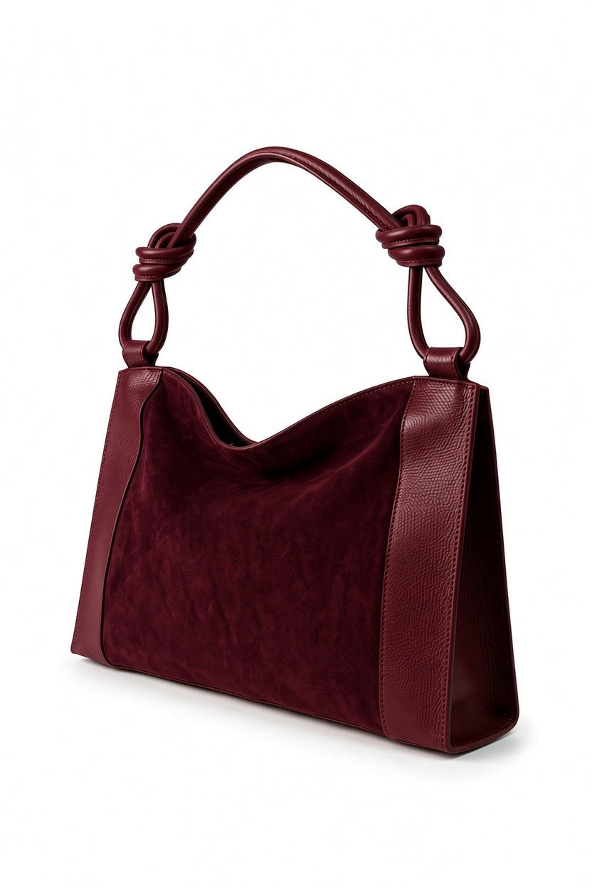 LEATHER AND SUEDE HANDBAG IN BORDEAUX deep red suede handbag featuring textured side panels and a shoulder strap with knot details.