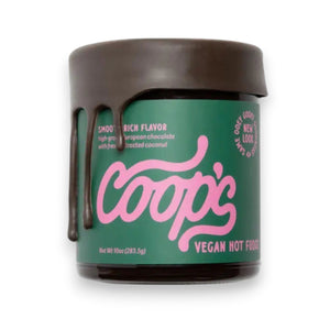 A jar of COOPS VEGAN HOT FUDGE features rich European chocolate fudge dripping down the side. The green label with pink lettering and a brown lid display the product name and description—ideal as an ice cream topping.