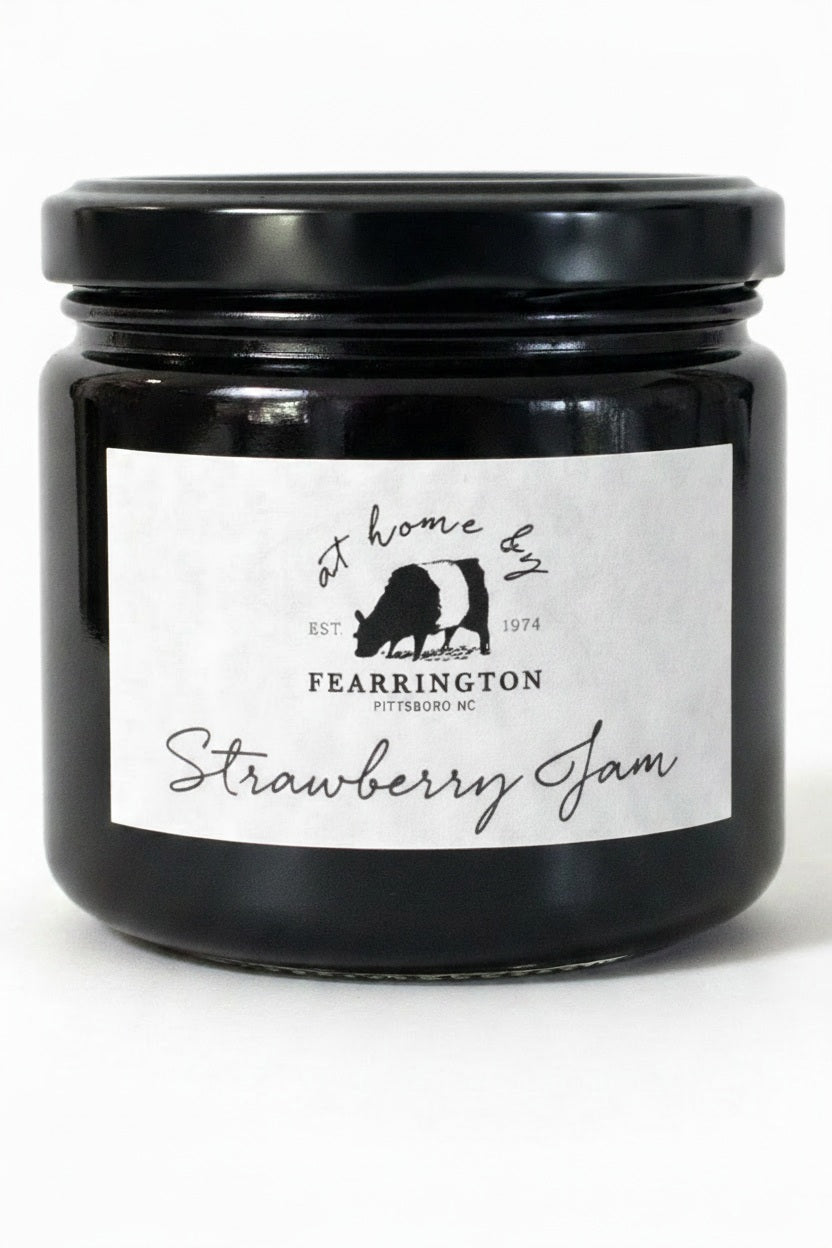Introducing the FEARRINGTON HOUSEMADE STRAWBERRY JAM from the FEARRINGTON SIGNATURE COLLECTION, this jar of delicious strawberry jam is adorned with a charming black and white striped ribbon tied around the lid. Perfect as a hostess gift, its label lists wholesome ingredients such as strawberry, vanilla, lemon, pectin, and sugar. This handmade treat may contain allergens and is a delightful choice for breakfast jam enthusiasts.