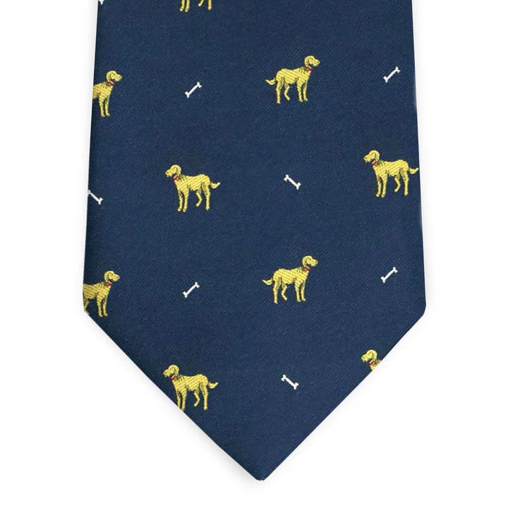 The BIRD DOG BAY - DOGGONE SILK TIE IN NAVY features a charming pattern of yellow dogs and white bones, making this silk tie from BIRD DOG BAY a stylish pick for any canine enthusiast.