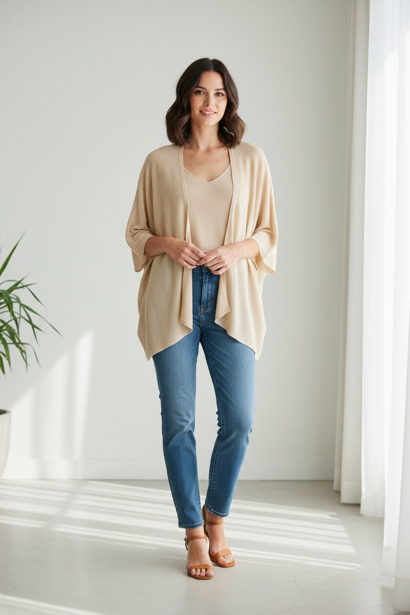The MOMONI - DIVINA KNIT CARDIGAN is a chic brown, open-front piece with a draped, asymmetrical hemline. Crafted in Italy with wide sleeves, it's perfect as evening wear against a plain white backdrop.