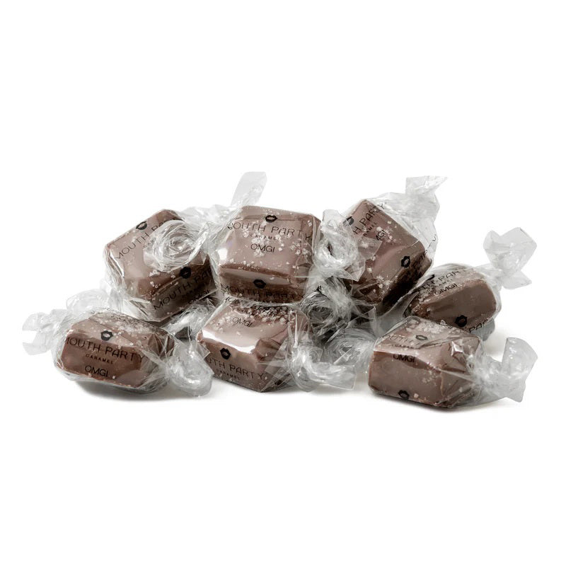A clear bag of MOUTH PARTY - OMG BAG caramels, including sea salt caramel, is tied with a copper satin bow. The label says &quot;Mouth Party Caramel OMG! NET WT. 6oz (170g).&quot; Brand: MOUTH PARTY.