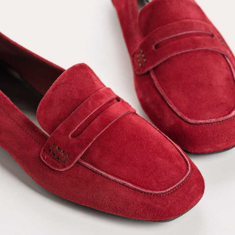 A close-up of the REQINS HEMA suede loafer in Cerise, featuring stitching details and a classic penny strap design, set against a light background.