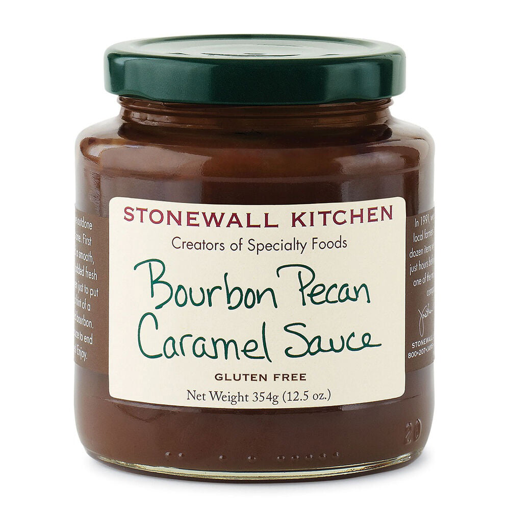 A jar of STONEWALL KITCHEN- BOURBON PECAN CRAMEL SAUCE with a dark green lid, featuring a white label. The label reads &quot;STONEWALL KITCHEN, Creators of Specialty Foods, Bourbon Pecan Caramel Sauce, Gluten Free, Net Weight 354g (12.5 oz).&quot; Perfect for elevating any dessert with rich caramel sauce and crunchy pecan pieces.
