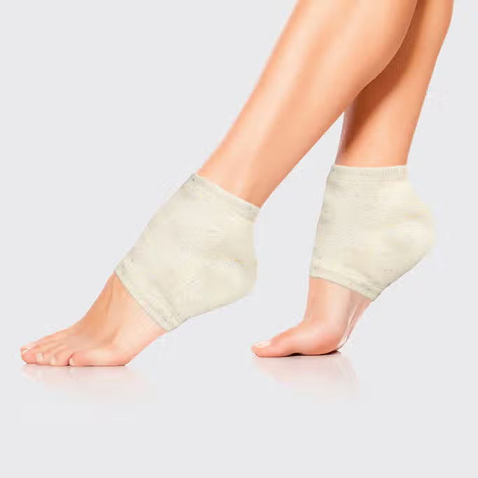 Displayed against a plain background are two light beige KITSCH - MOISTURIZING HEEL SOCKS with subtle multicolored speckles. They feature an insulated gel lining, positioned side by side to show their knit texture, promising to hydrate and soften your skin.
