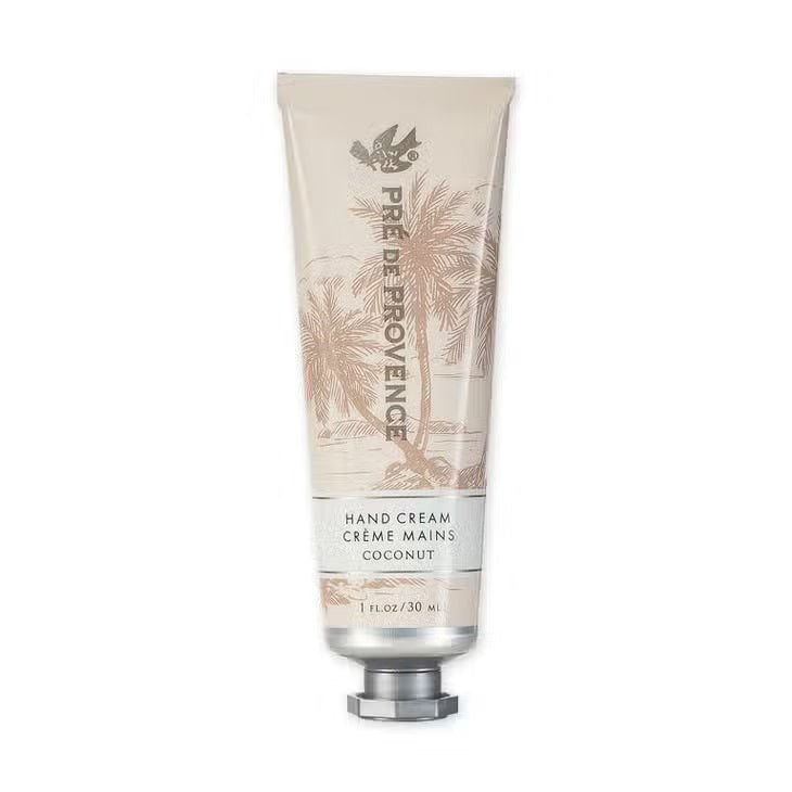 A 30 ml tube of HAND CREAM - COCONUT from EUROPEAN SOAPS, LLC, enriched with organic shea butter for ultimate moisturizing. The tube is decorated with illustrations of palm trees and has a shiny cap. The label reads "Hand Cream Creme Mains Coconut 1 FL OZ / 30 ml.