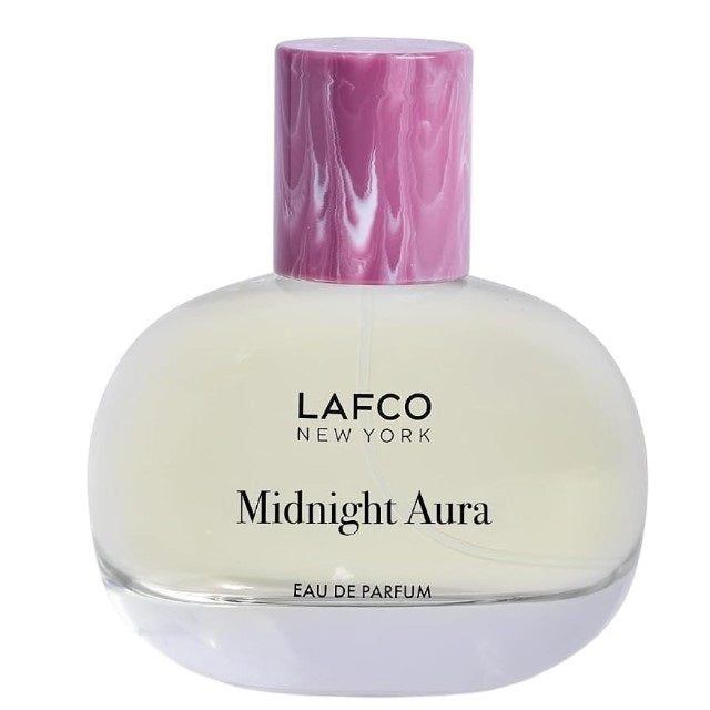 A LAFCO Fine Fragrance, Midnight Aura 50ml box rests on a rock, framed by flowers and green cactus pads in the background, capturing the essence of this alluring fruity perfume crafted with essential oils.