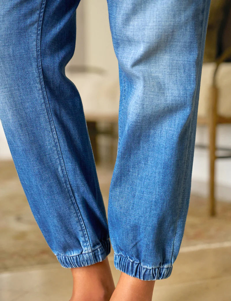 FRANK &amp; EILEEN Jameson Utility Jogger Jean in 1968 Wash: light blue denim joggers with a mid-rise waistband, front patch pockets, and elastic cuffs at the ankles, shown flat on a white background.