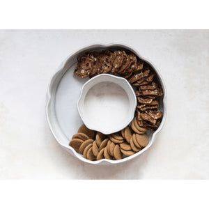 The CREATIVE COOP RING SERVING DISH is a white ceramic dish with a lid, made from 100% stoneware for lasting durability and timeless elegance.