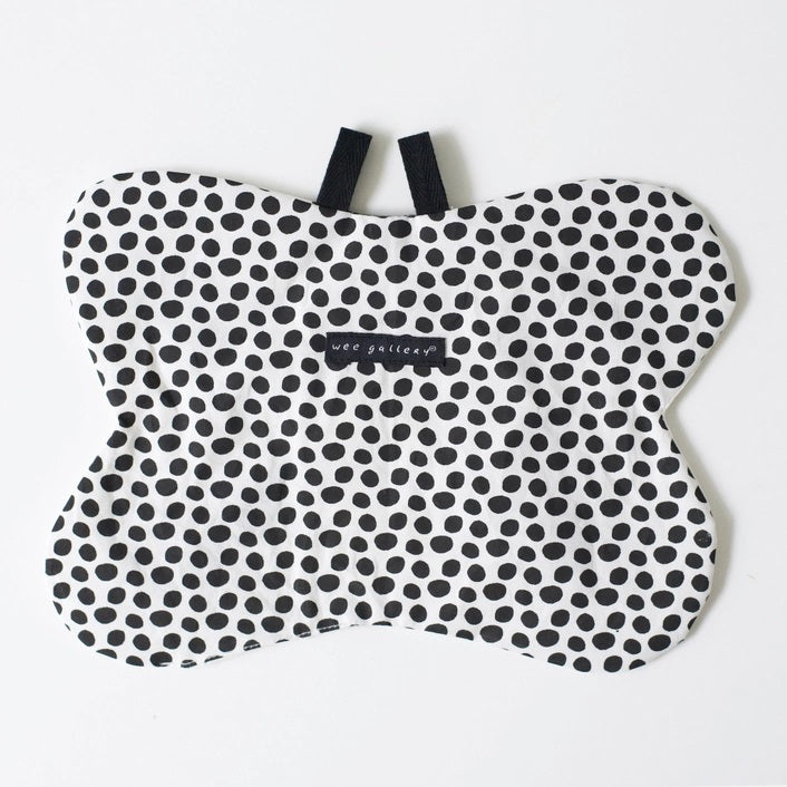 The WEE GALLERY - BUTTERFLY ORGANIC CRINKLE is a children's soft fabric toy, crafted from organic cotton. It features a butterfly shape with a smiling face in the center and a striped yellow and black body. The white wings are adorned with black patterns and yellow accents, providing visual stimulation. Additionally, it includes a small loop at the top for hanging.