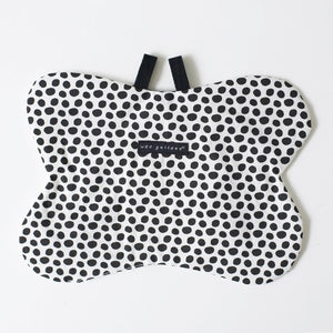 The WEE GALLERY - BUTTERFLY ORGANIC CRINKLE is a children's soft fabric toy, crafted from organic cotton. It features a butterfly shape with a smiling face in the center and a striped yellow and black body. The white wings are adorned with black patterns and yellow accents, providing visual stimulation. Additionally, it includes a small loop at the top for hanging.