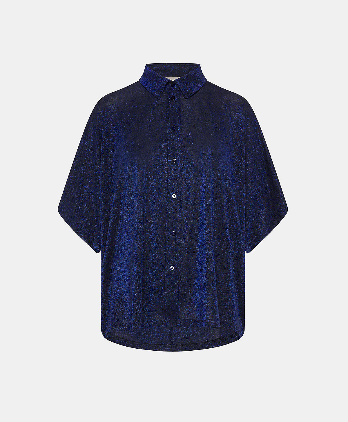 A person in a MOMONI - BROOKLYN blue shirt with a classic collar, paired with colorful beaded necklaces and tucked into striped pants. The loose-fitting, short-sleeve button-up stands out against the plain light background.